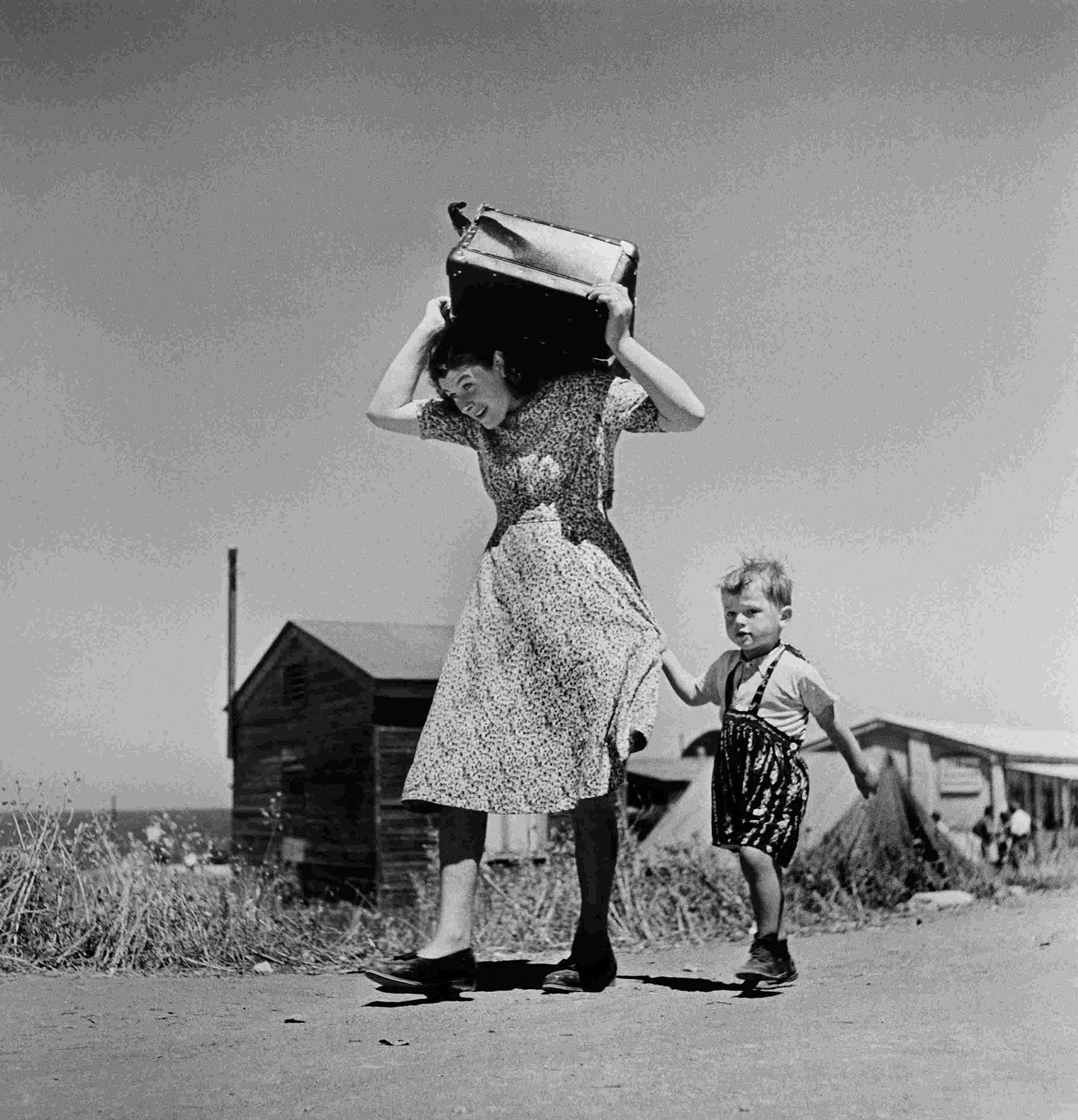 Exile Robert Capa Woman carrying luggage accompanied by a small boy. Haifa Israel 1949 50 Magnum Photos